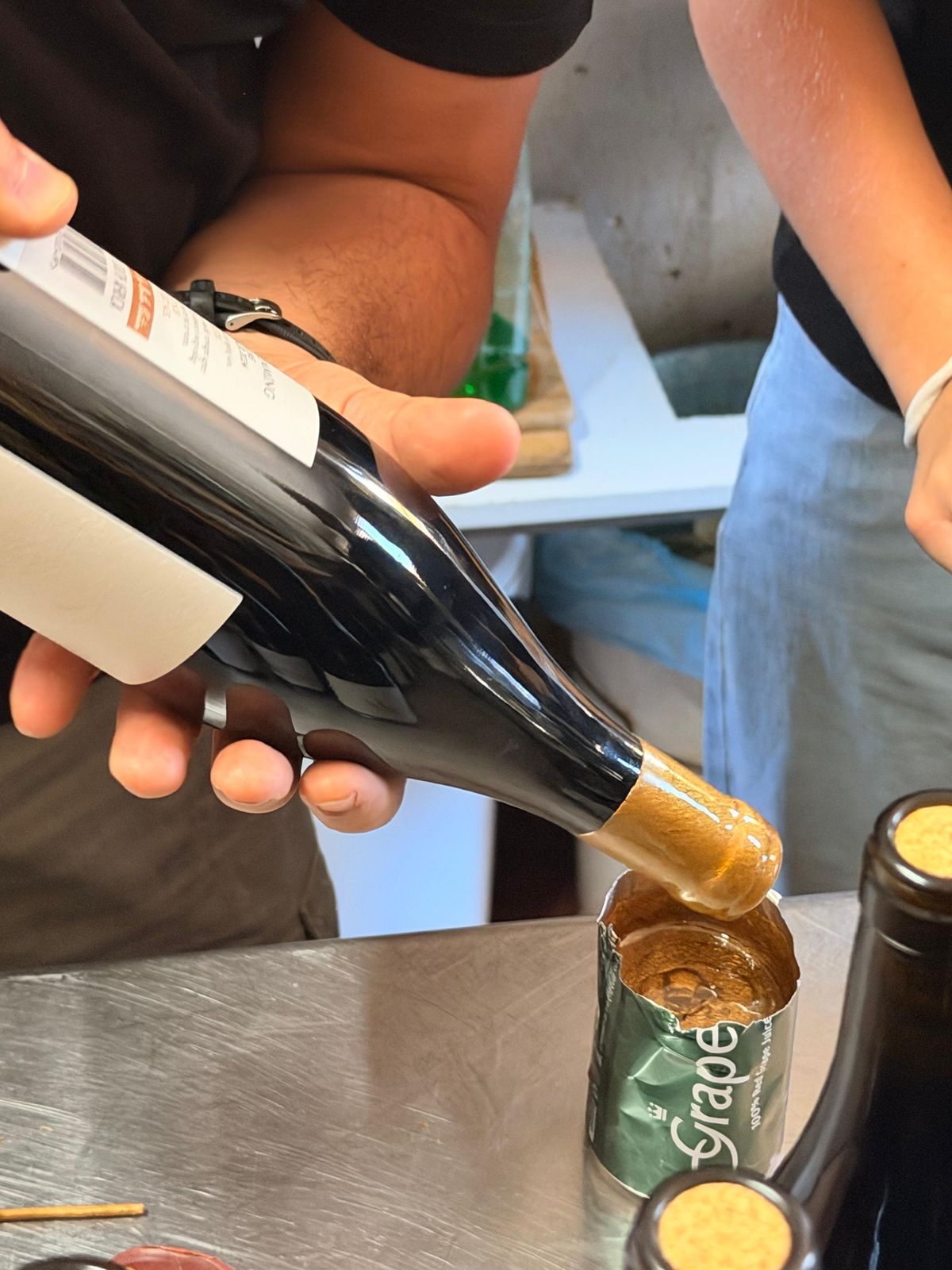 Dipping a bottle neck in gold wax